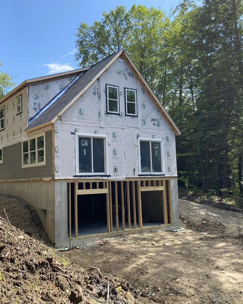 The modular home in the woods two days after set day, wrapped and weather tight